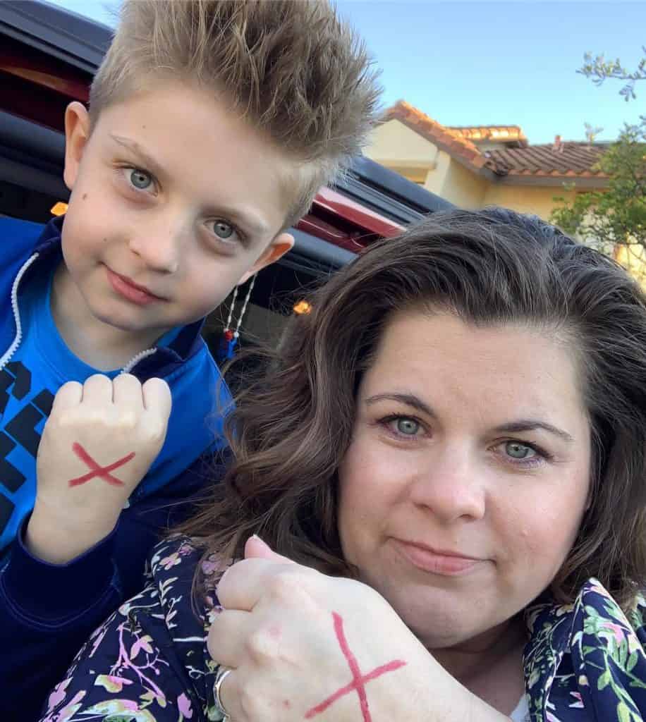 James and Tamitha show a cross on their hands