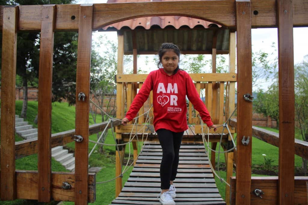 girl standing at playground of Project M25