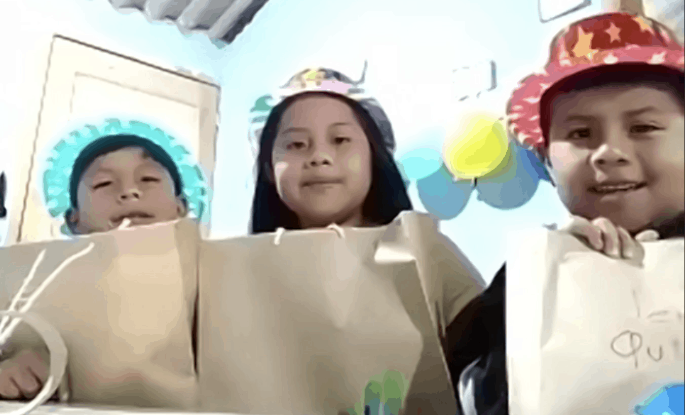 Kids smiling to camera with paper bags
